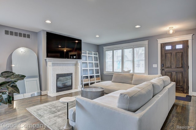 995 Cambridge Rd, Berkley, MI 48072 - living area featuring a tiled fireplace, dark wood-type flooring, and recessed lighting