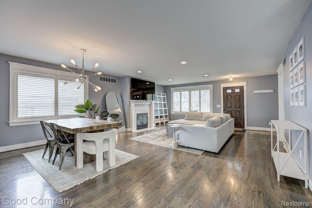 995 Cambridge Rd, Berkley, MI 48072 - dining area featuring a chandelier, a glass covered fireplace, dark wood-style floors, and recessed lighting