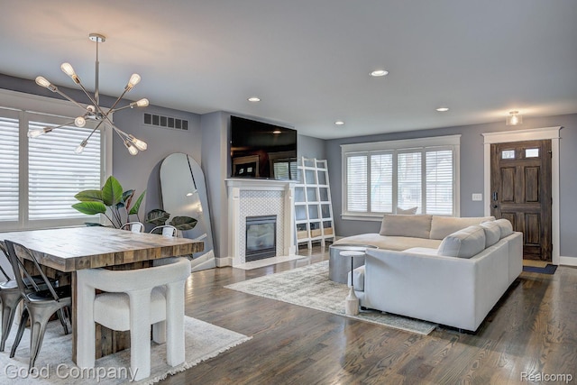 995 Cambridge Rd, Berkley, MI 48072 - living area featuring a chandelier, a tile fireplace, dark wood-style flooring, and recessed lighting