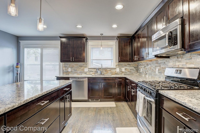 995 Cambridge Rd, Berkley, MI 48072 - kitchen with appliances with stainless steel finishes, light wood-style floors, dark brown cabinets, and recessed lighting