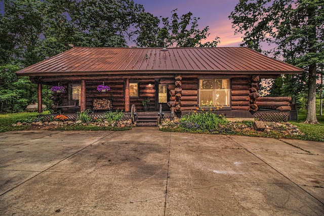 12170 Riethmiller Rd, Grass Lake, MI 49240 - log-style house featuring covered porch, log siding, and a metal roof