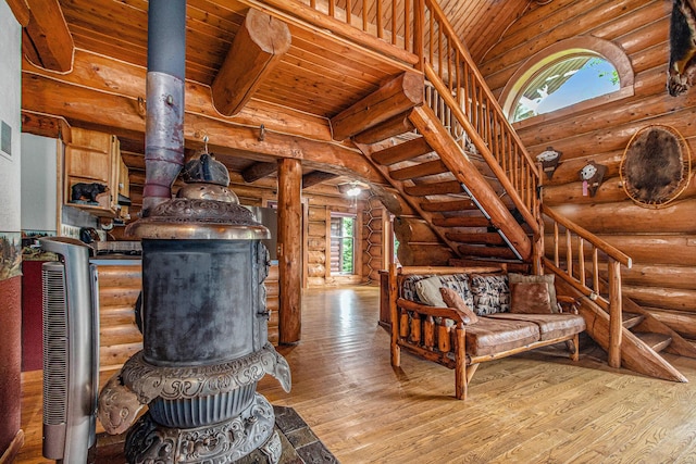 12170 Riethmiller Rd, Grass Lake, MI 49240 - living room with log walls, wood-type flooring, stairway, and a wood ceiling with exposed beams
