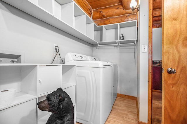 12170 Riethmiller Rd, Grass Lake, MI 49240 - washroom featuring separate washer and dryer, light wood-style flooring, and rustic walls
