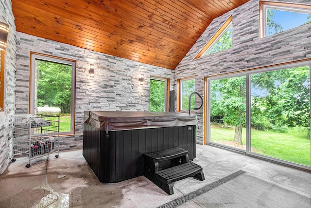 12170 Riethmiller Rd, Grass Lake, MI 49240 - sunroom / solarium with a jacuzzi, lofted ceiling, and a wood stove