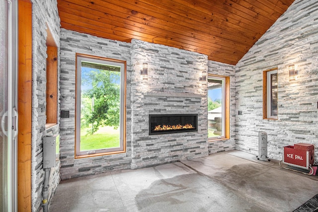 12170 Riethmiller Rd, Grass Lake, MI 49240 - unfurnished living room featuring lofted ceiling, healthy amount of natural light, wooden ceiling, and a glass covered fireplace