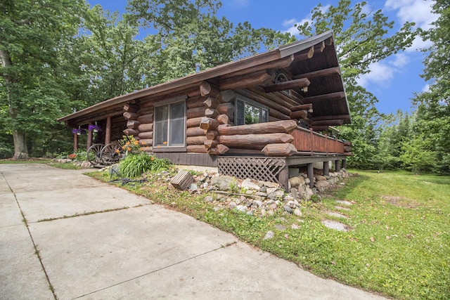 12170 Riethmiller Rd, Grass Lake, MI 49240 - view of property exterior with log exterior and a lawn