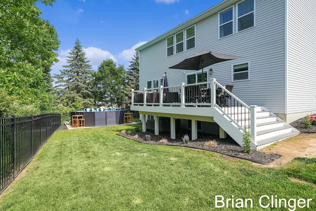 3293 Creek Ridge Dr, Hudsonville, MI 49426 - rear view of house featuring a deck, a swimming pool, a fenced backyard, and stairway
