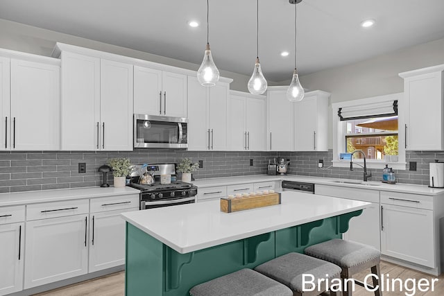 3293 Creek Ridge Dr, Hudsonville, MI 49426 - kitchen featuring appliances with stainless steel finishes, a breakfast bar, a center island, light countertops, and recessed lighting
