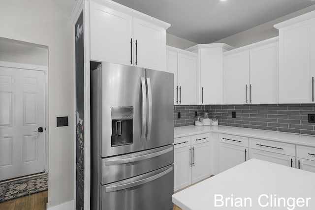 3293 Creek Ridge Dr, Hudsonville, MI 49426 - kitchen with stainless steel fridge, light countertops, white cabinets, and tasteful backsplash