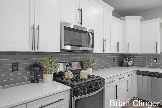 3293 Creek Ridge Dr, Hudsonville, MI 49426 - kitchen featuring appliances with stainless steel finishes, light countertops, white cabinetry, and backsplash