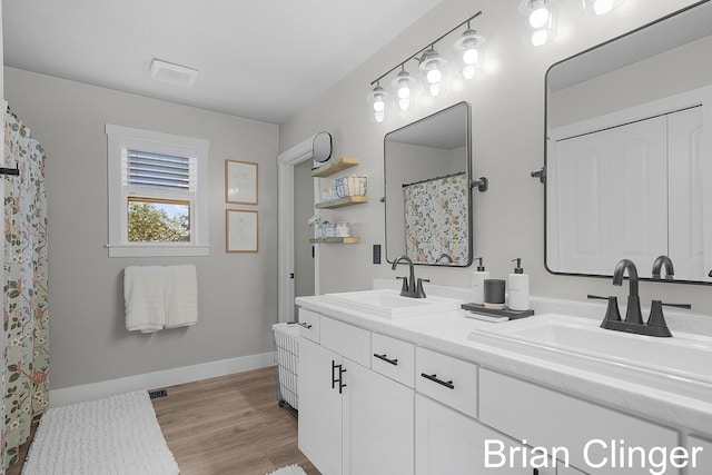 3293 Creek Ridge Dr, Hudsonville, MI 49426 - full bathroom with double vanity and wood finished floors