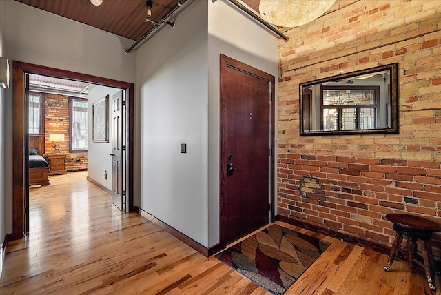 333 State St Unit 5, Saint Joseph, MI 49085 - entrance foyer featuring light wood finished floors and brick wall
