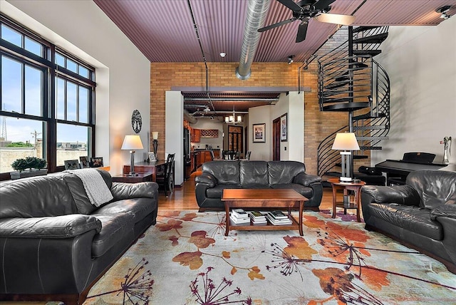 333 State St Unit 5, Saint Joseph, MI 49085 - living area with healthy amount of natural light, a high ceiling, a ceiling fan, and brick wall