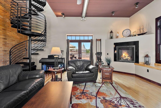 333 State St Unit 5, Saint Joseph, MI 49085 - living room featuring wood finished floors, a fireplace, rail lighting, and wooden ceiling