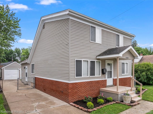 7220 Dodge Ave, Warren, MI 48091 - view of front of home featuring brick siding, an outdoor structure, concrete driveway, and a detached garage