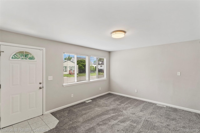 7220 Dodge Ave, Warren, MI 48091 - carpeted entrance foyer featuring baseboards and tile patterned flooring