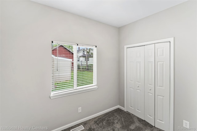 7220 Dodge Ave, Warren, MI 48091 - unfurnished bedroom featuring dark carpet and a closet