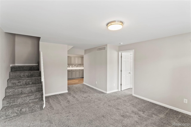 7220 Dodge Ave, Warren, MI 48091 - unfurnished living room with carpet flooring and stairs