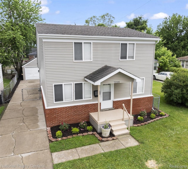 7220 Dodge Ave, Warren, MI 48091 - view of front of property featuring brick siding, a detached garage, an outdoor structure, and roof with shingles