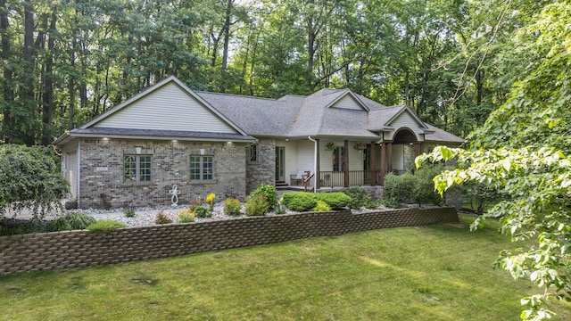 1255 White Pine Dr SW, Grand Rapids, MI 49534 - view of front of home featuring a front lawn, covered porch, brick siding, and roof with shingles