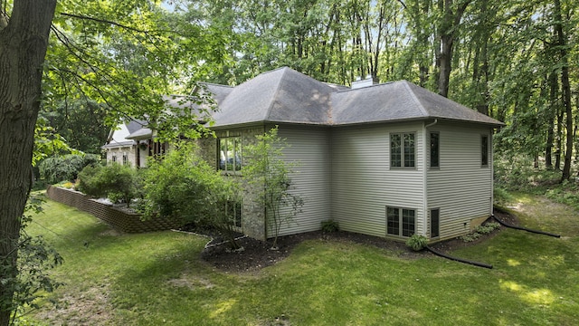 1255 White Pine Dr SW, Grand Rapids, MI 49534 - view of home's exterior with a lawn and roof with shingles