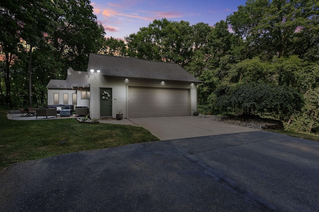 1255 White Pine Dr SW, Grand Rapids, MI 49534 - view of front of home with an outdoor living space, a garage, concrete driveway, and a front lawn