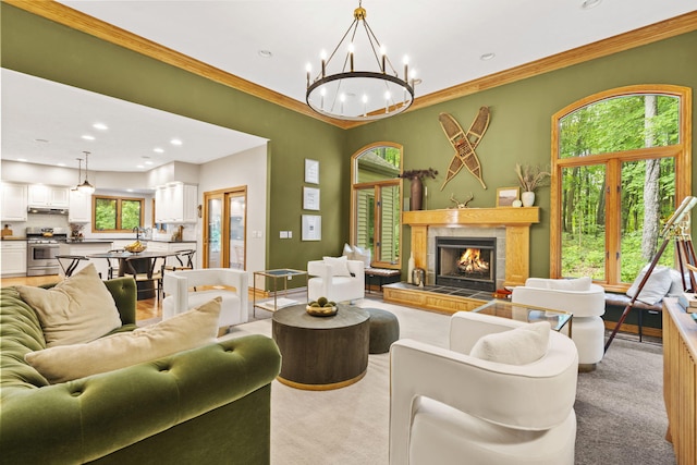 1255 White Pine Dr SW, Grand Rapids, MI 49534 - living area with light colored carpet, a chandelier, crown molding, a tiled fireplace, and recessed lighting