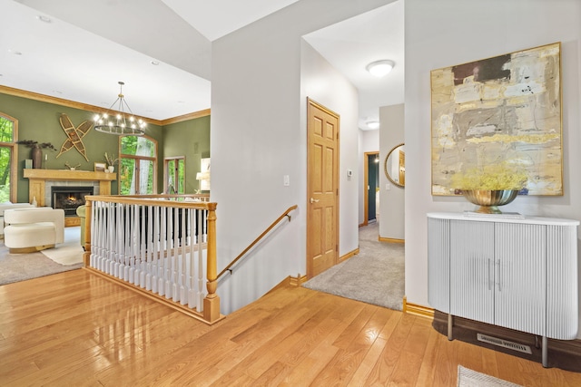 1255 White Pine Dr SW, Grand Rapids, MI 49534 - corridor featuring an upstairs landing, hardwood / wood-style flooring, plenty of natural light, and a chandelier
