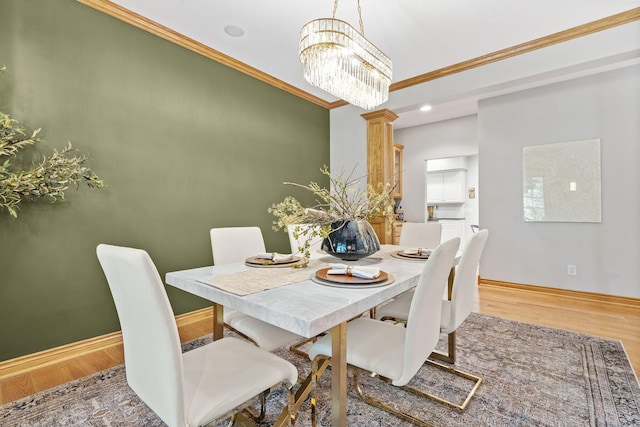 1255 White Pine Dr SW, Grand Rapids, MI 49534 - dining space with wood finished floors, ornamental molding, a chandelier, and recessed lighting