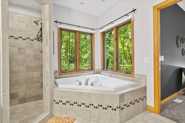 1255 White Pine Dr SW, Grand Rapids, MI 49534 - bathroom with a jetted tub, healthy amount of natural light, a tile shower, and tile patterned flooring