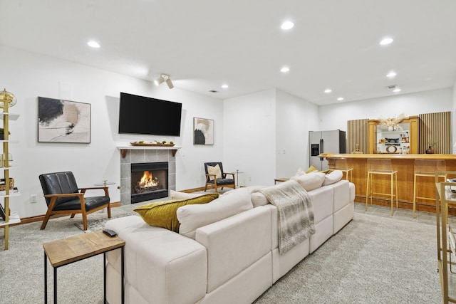 1255 White Pine Dr SW, Grand Rapids, MI 49534 - living room with a tiled fireplace, recessed lighting, and light colored carpet