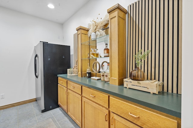 1255 White Pine Dr SW, Grand Rapids, MI 49534 - kitchen featuring freestanding refrigerator, dark countertops, and light tile patterned floors