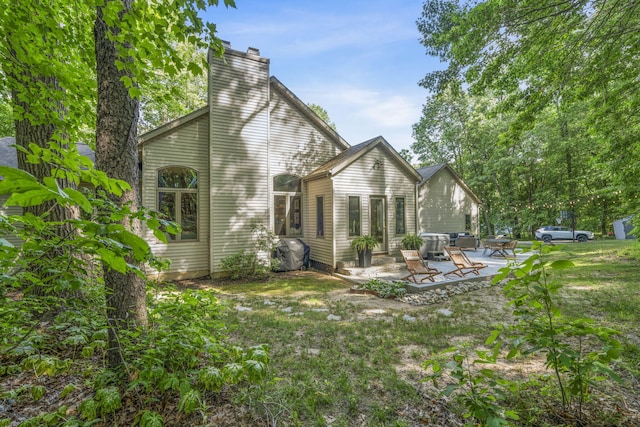 1255 White Pine Dr SW, Grand Rapids, MI 49534 - back of property featuring a patio and a chimney