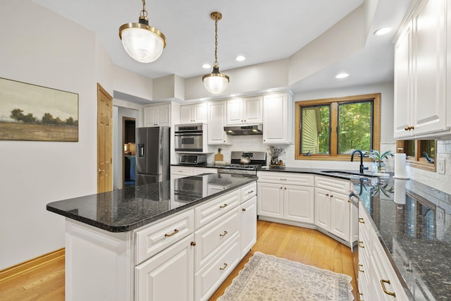 1255 White Pine Dr SW, Grand Rapids, MI 49534 - kitchen with stainless steel appliances, under cabinet range hood, backsplash, white cabinets, and recessed lighting