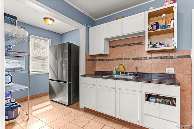 6842 Jonathon St, Dearborn, MI 48126 - kitchen featuring freestanding refrigerator, white cabinets, dark countertops, and light tile patterned floors