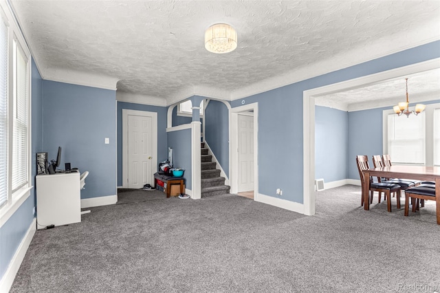 6842 Jonathon St, Dearborn, MI 48126 - carpeted living area featuring a chandelier, a textured ceiling, and stairway