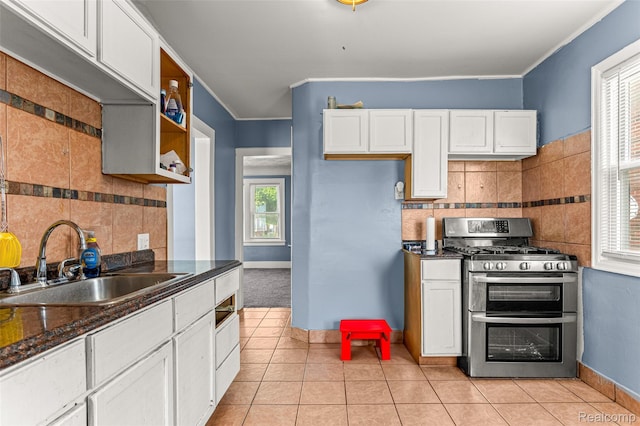 6842 Jonathon St, Dearborn, MI 48126 - kitchen with double oven range, tasteful backsplash, white cabinetry, light tile patterned flooring, and ornamental molding