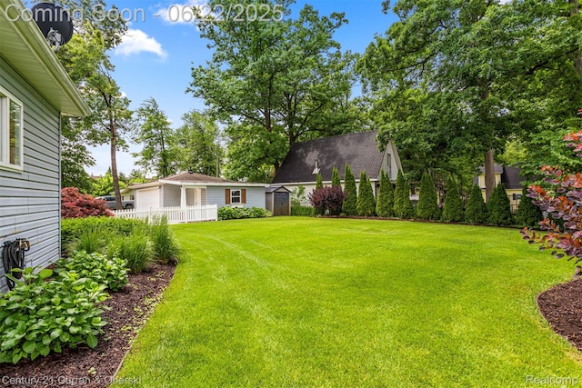 5443 Ridgemont St, Howell, MI 48843 - view of yard featuring a storage shed and a garage