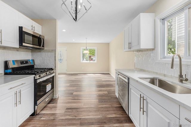 27336 Alger Blvd, Bloomfield Hills, MI 48071 - kitchen with appliances with stainless steel finishes, light countertops, recessed lighting, tasteful backsplash, and white cabinetry