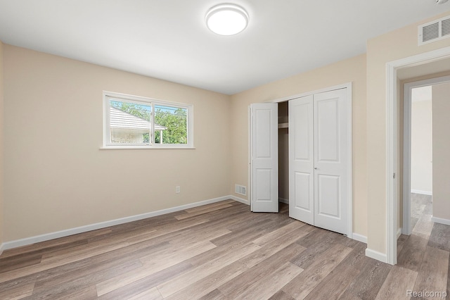 27336 Alger Blvd, Bloomfield Hills, MI 48071 - unfurnished bedroom featuring light wood finished floors and a closet