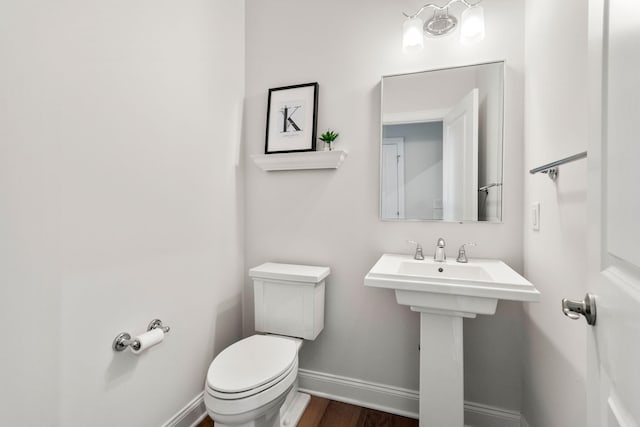 3078 N Spurway Dr, Ann Arbor, MI 48105 - half bathroom featuring baseboards and wood finished floors