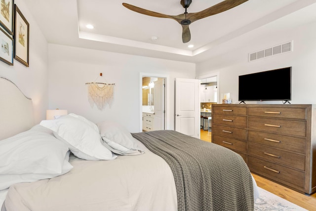 3078 N Spurway Dr, Ann Arbor, MI 48105 - bedroom with light wood-type flooring, recessed lighting, a raised ceiling, ensuite bath, and ceiling fan