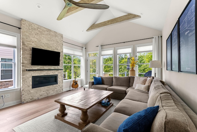 3078 N Spurway Dr, Ann Arbor, MI 48105 - living area featuring beamed ceiling, wood finished floors, ceiling fan, high vaulted ceiling, and a stone fireplace