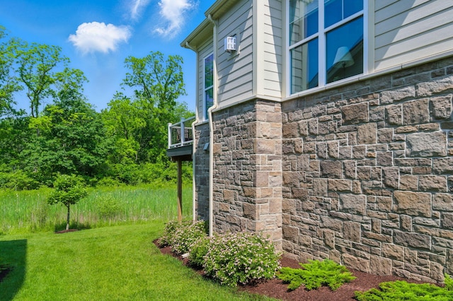 3078 N Spurway Dr, Ann Arbor, MI 48105 - view of side of property featuring stone siding and a lawn