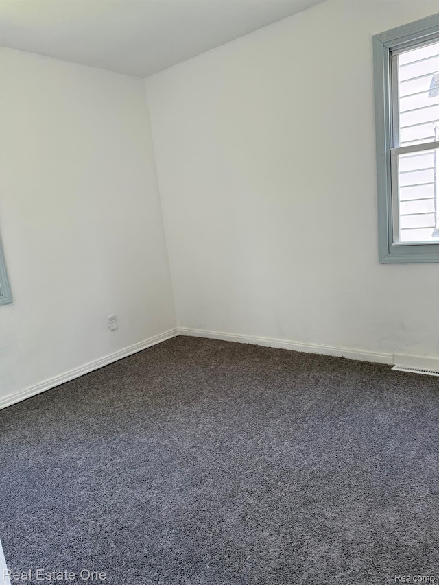 6365 Longacre St, Detroit, MI 48228 - spare room with dark colored carpet and baseboards