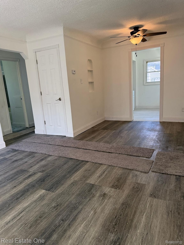 6365 Longacre St, Detroit, MI 48228 - empty room featuring a textured ceiling, dark wood-style floors, and a ceiling fan