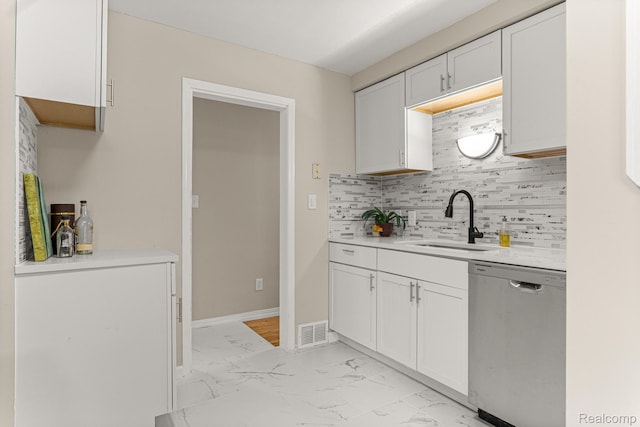 23621 Joy Rd, Redford, MI 48127 - kitchen with stainless steel dishwasher, light marble finish floors, light countertops, backsplash, and white cabinetry