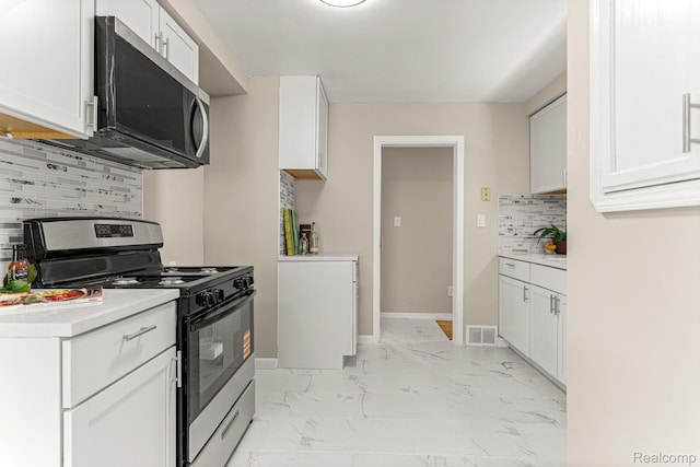 23621 Joy Rd, Redford, MI 48127 - kitchen with stainless steel appliances, backsplash, light marble finish flooring, light countertops, and white cabinets