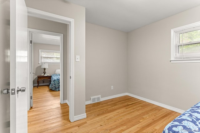 23621 Joy Rd, Redford, MI 48127 - unfurnished bedroom featuring light wood-style floors and baseboards