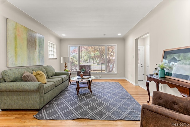 23621 Joy Rd, Redford, MI 48127 - living room with arched walkways, wood finished floors, and recessed lighting